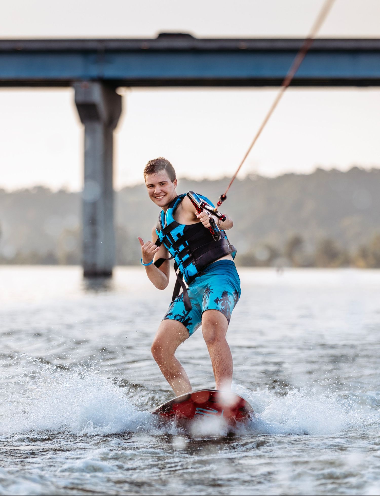 Dynamic sequence of senior performing wakeboarding tricks on a lake. Middle TN senior photographer