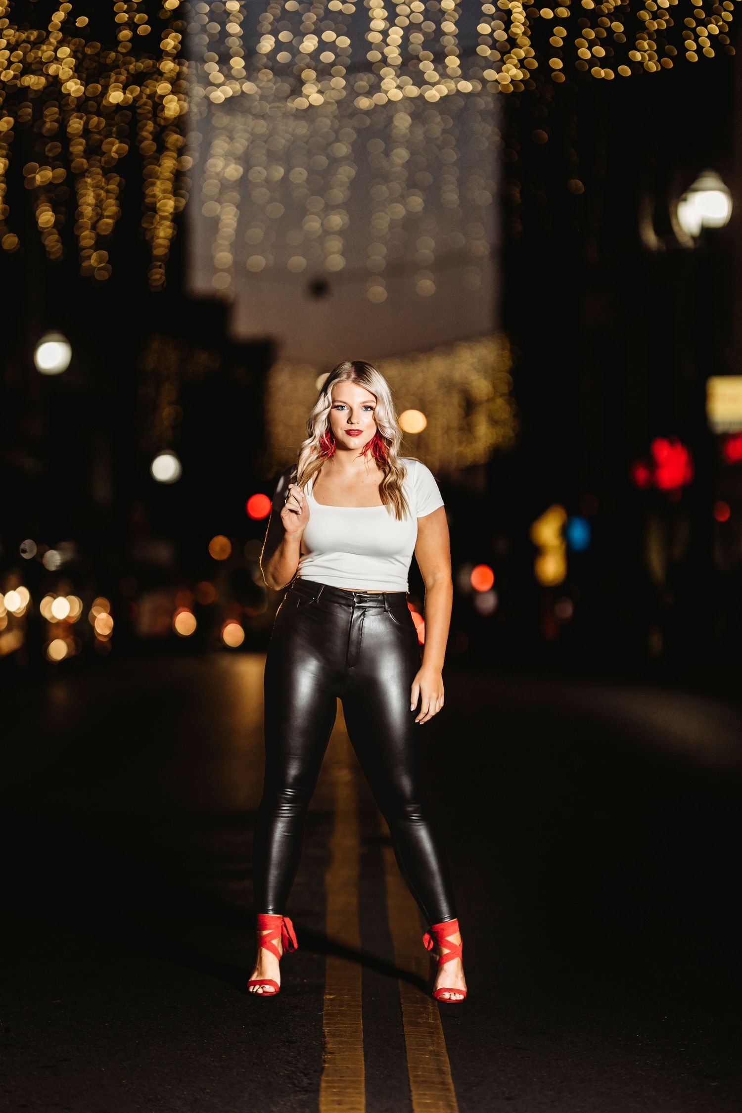 Nighttime fashion portrait with bokeh lights in background. Middle TN senior photographer