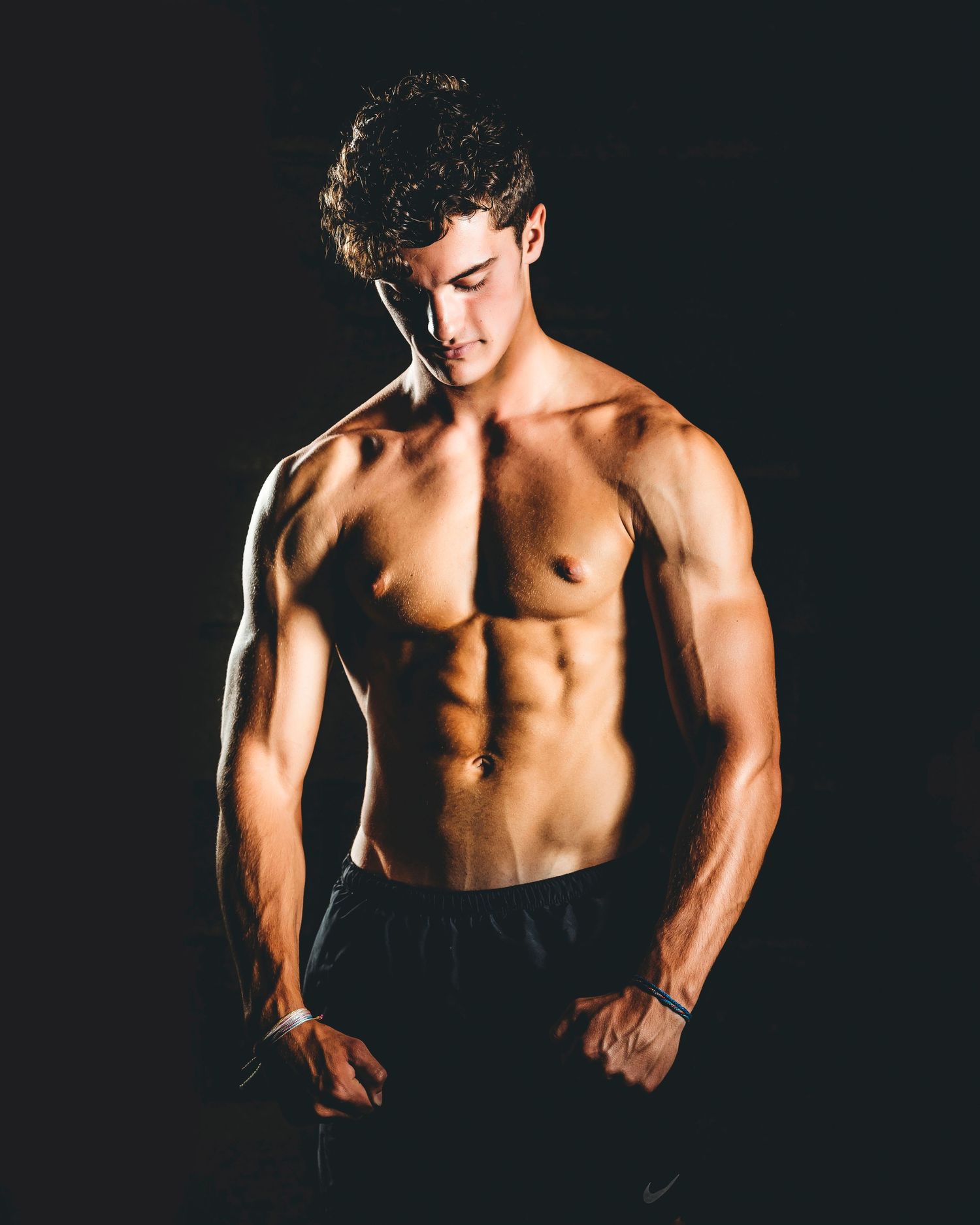 Dramatic black and white fitness photo showing muscular torso in studio lighting. Middle TN senior photographer