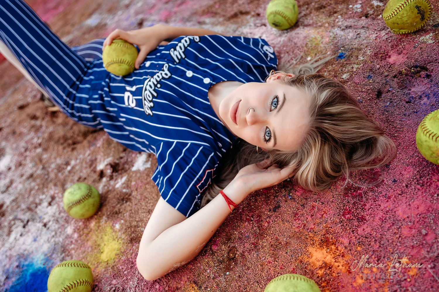 Baseball themed photo with softballs scattered on colorful textured ground.Middle TN senior photographer