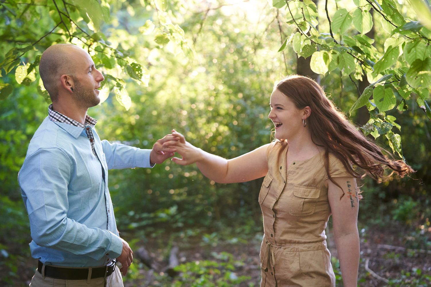 A couple dances and spins in a sunlit garden setting.