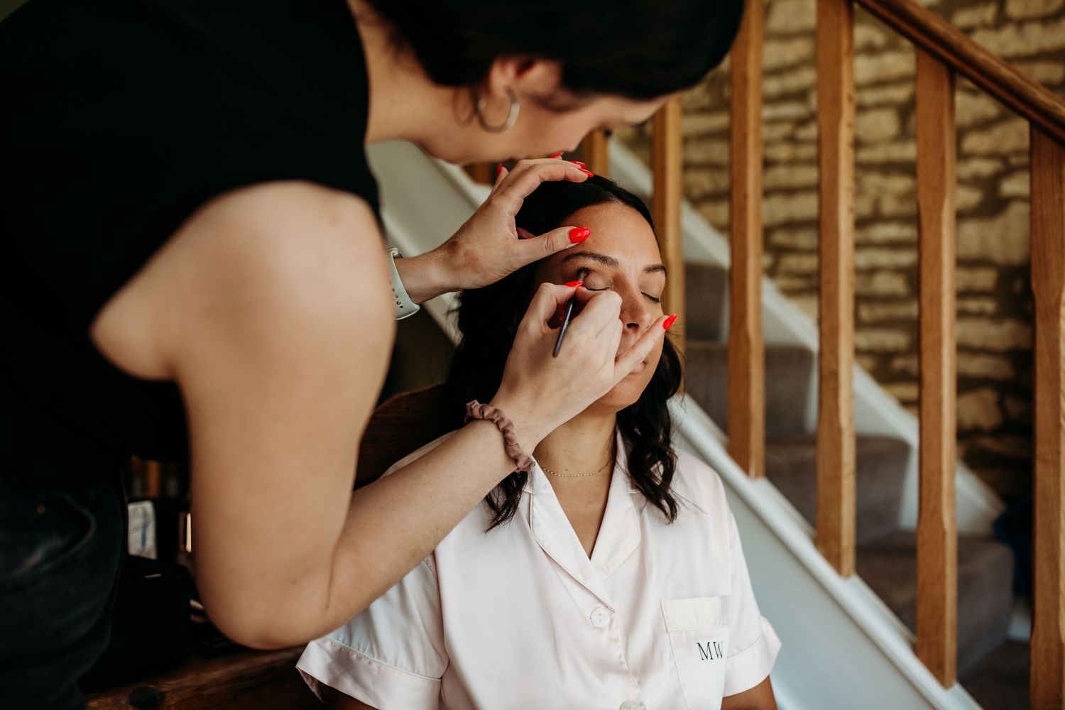 Makeup application session in progress on staircase.