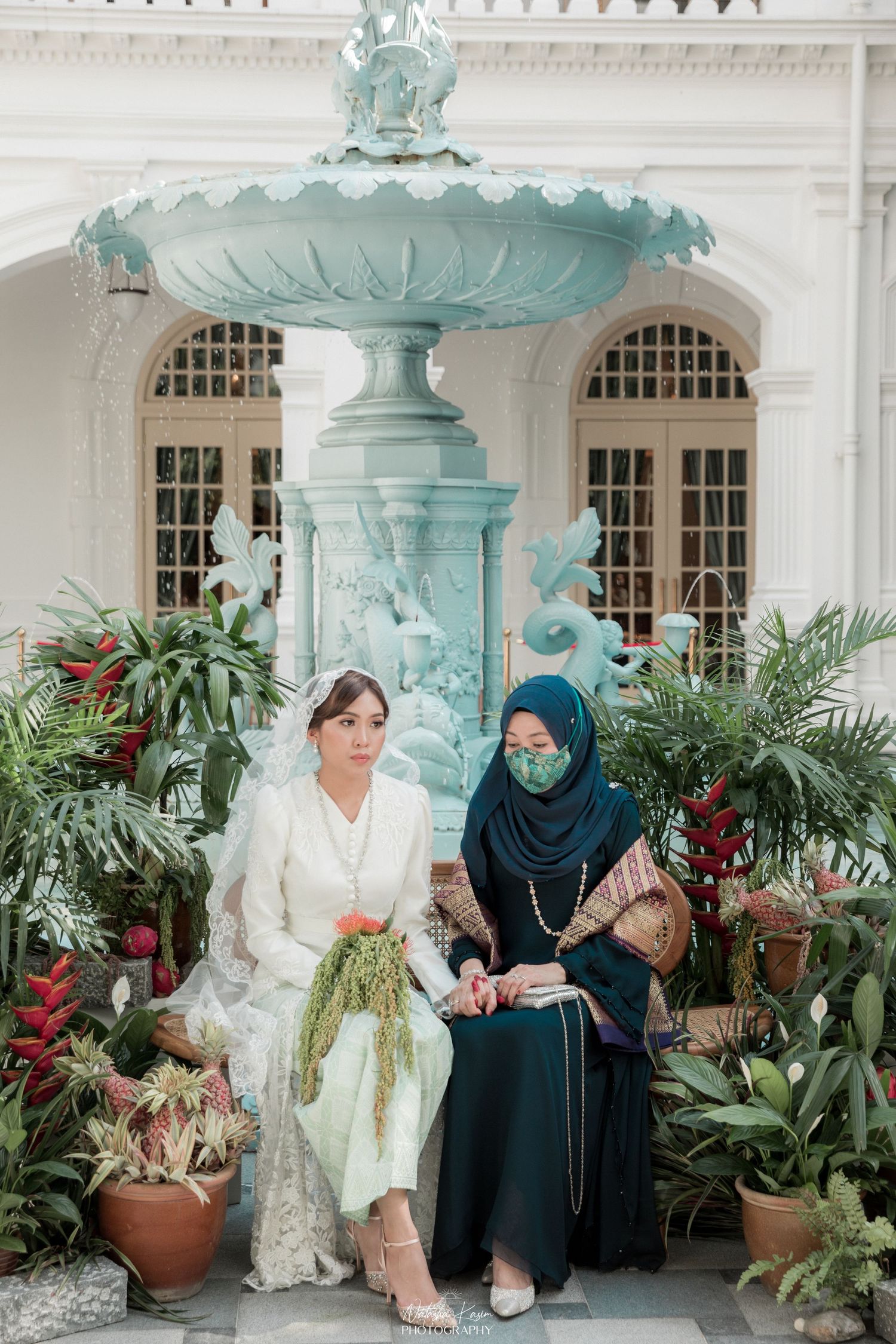 Elegant courtyard setting with mint green fountain and traditional architectural details.