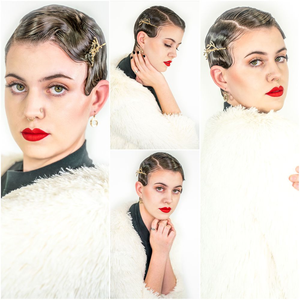 Model with dark brown hair, black gauzy clothes, and a white faux fur coat, styled with 1920s hair and makeup for a soft yet edgy look.