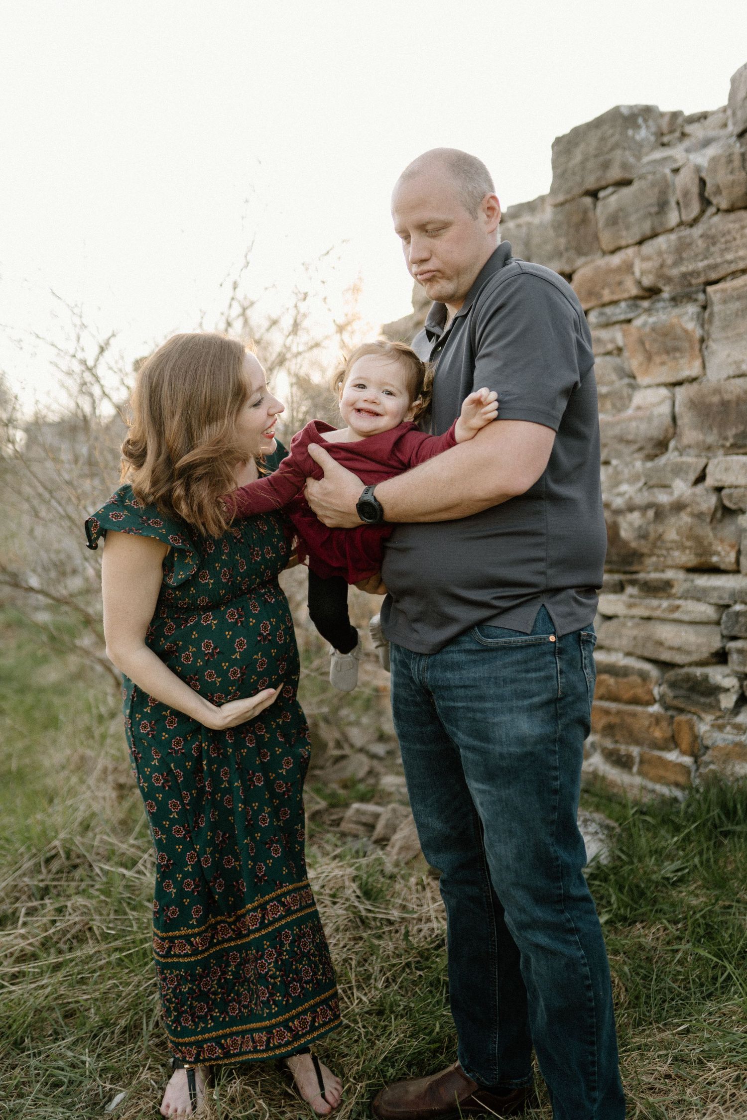 A happy moment shared between mom, dad and little girl by Alexis Anne Photography