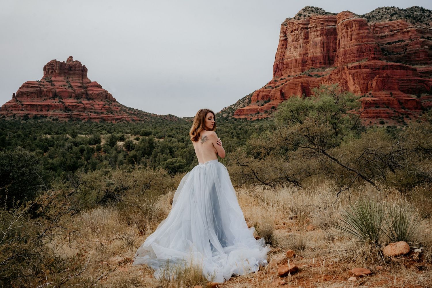 A light blue tulle wedding dress photographed against red rock formations in Sedona.