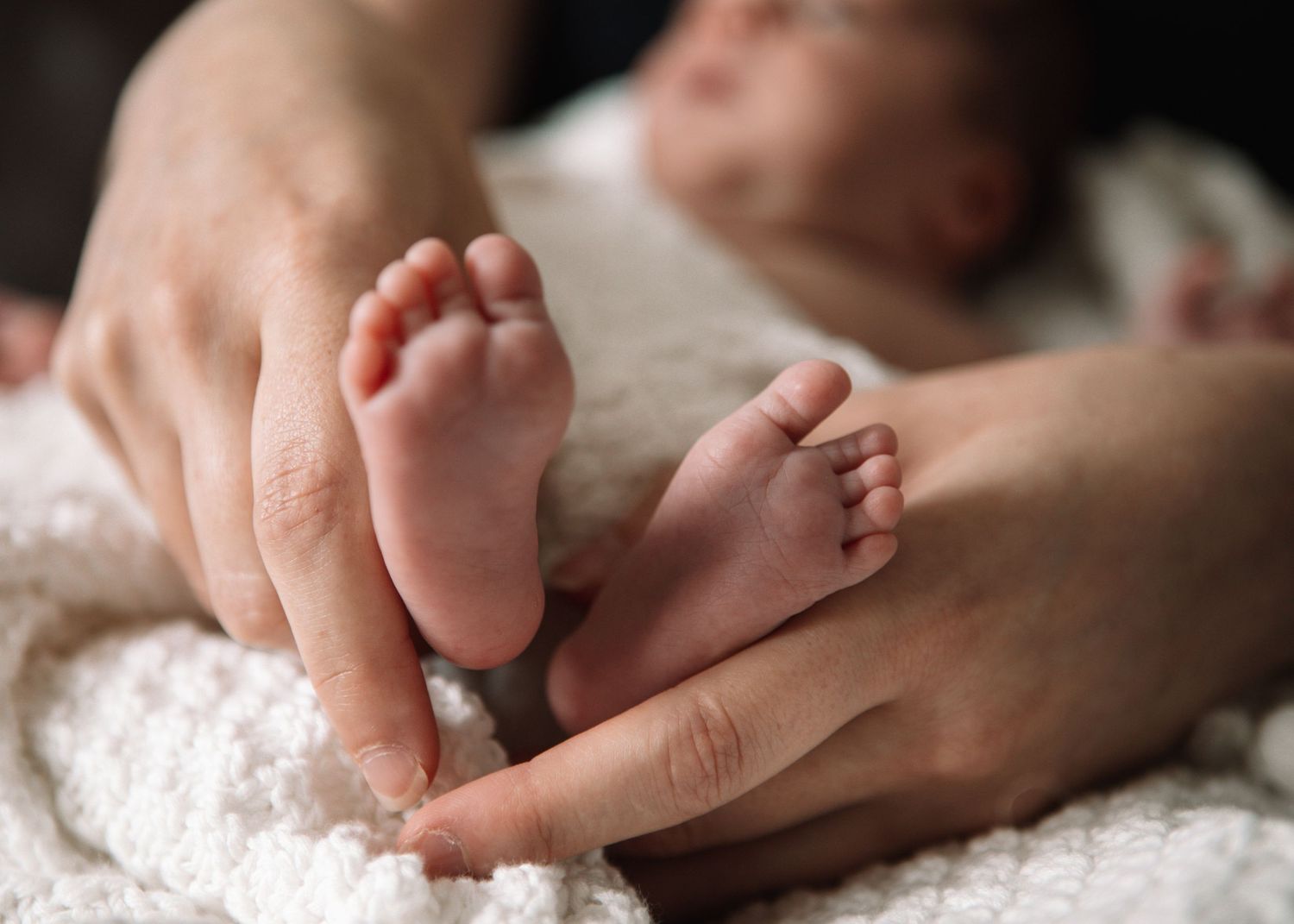 New born at home photo shoot with Cornwall new born photographer tiny feet big hands