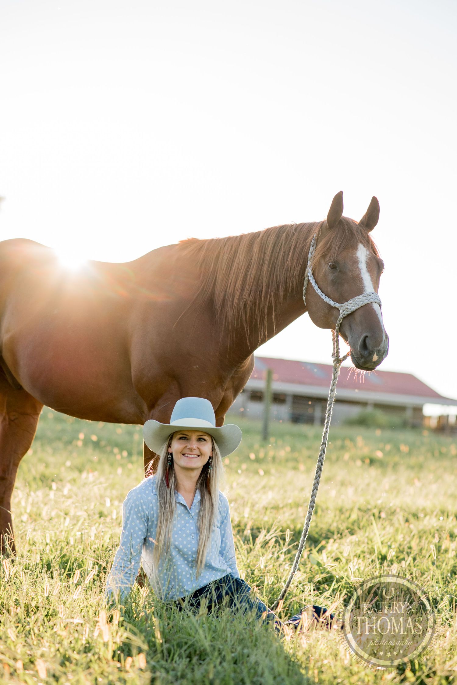 A backlit portrait of a person and their horse in a sunlit field during golden hour.
