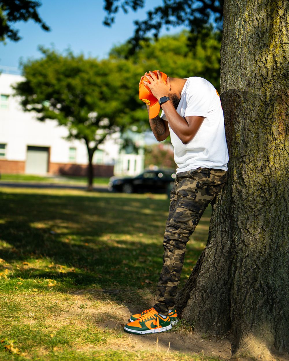 Urban portrait of man wearing white shirt and camo pants — relaxed fashion photo by Timoy B Photography.
