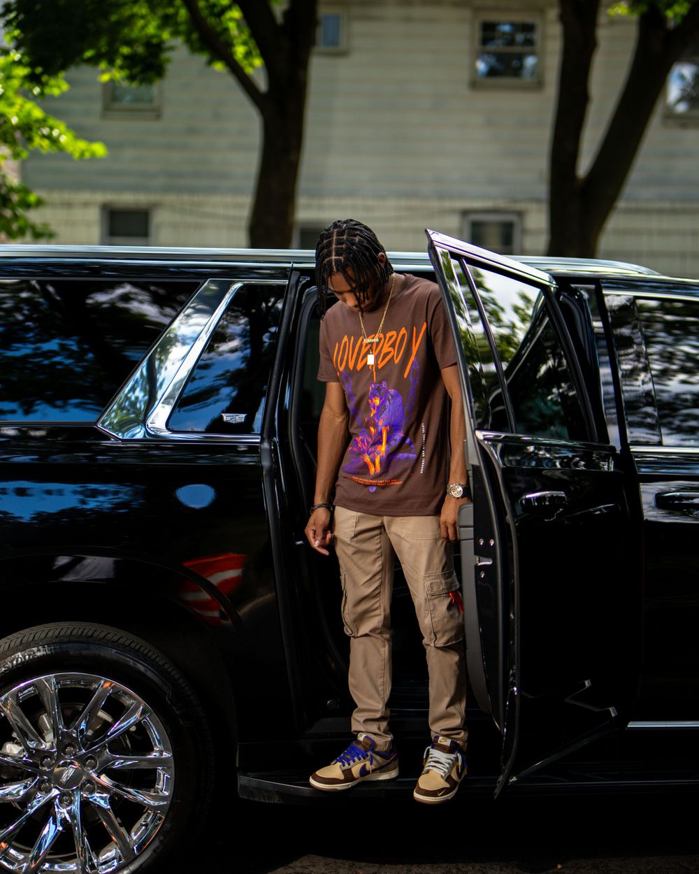Man stepping out of luxury black vehicle — cinematic lifestyle photo by Timoy B Photography.