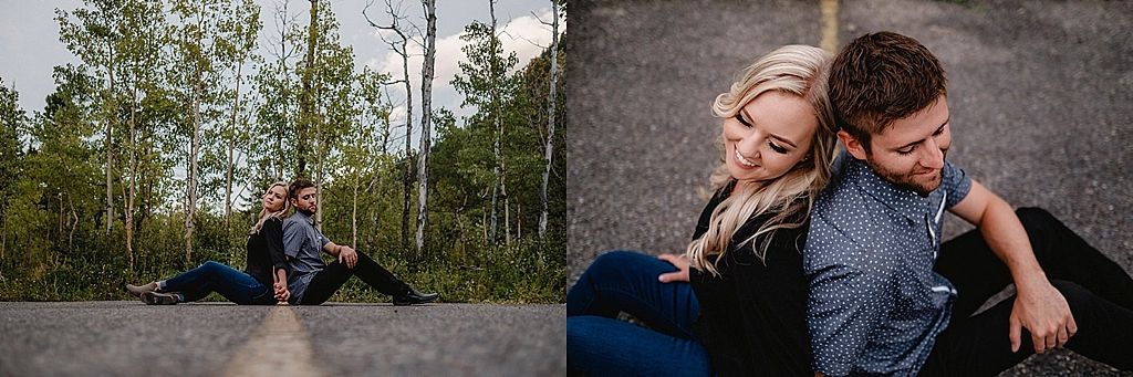 Intimate couple portrait session on rocky terrain with natural outdoor lighting.