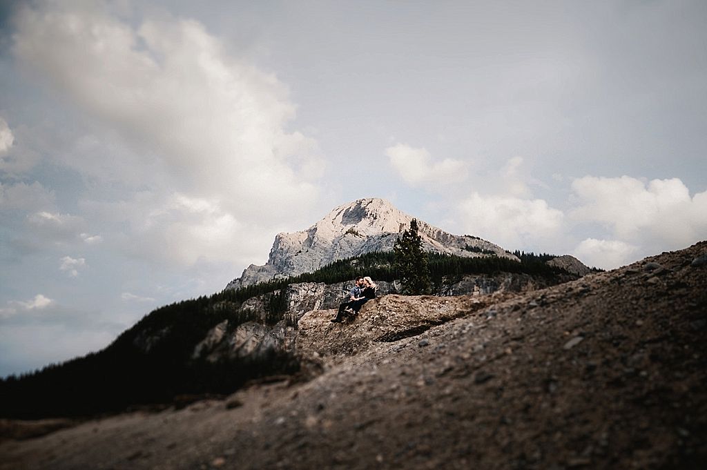 Majestic rocky mountain peak rises against cloudy sky in dramatic landscape shot.