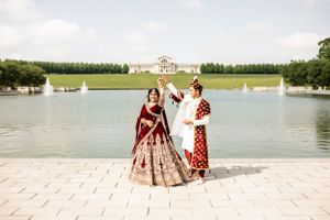 Traditional cultural wedding celebration by a scenic waterfront.
