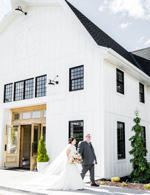 Modern white wedding venue exterior with black-trimmed windows.