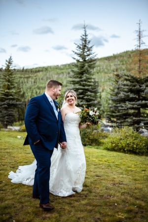 Wedding portraits in mountain setting with evergreen trees and natural landscape.