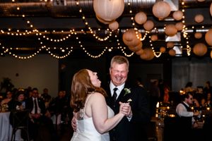 Wedding reception venue decorated with paper lanterns and string lights creating a romantic atmosphere.