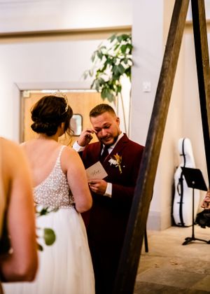 Intimate wedding moments captured in a bright indoor venue with wooden beams.