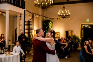 Wedding reception venue decorated with chandeliers and elegant lighting for evening celebration.