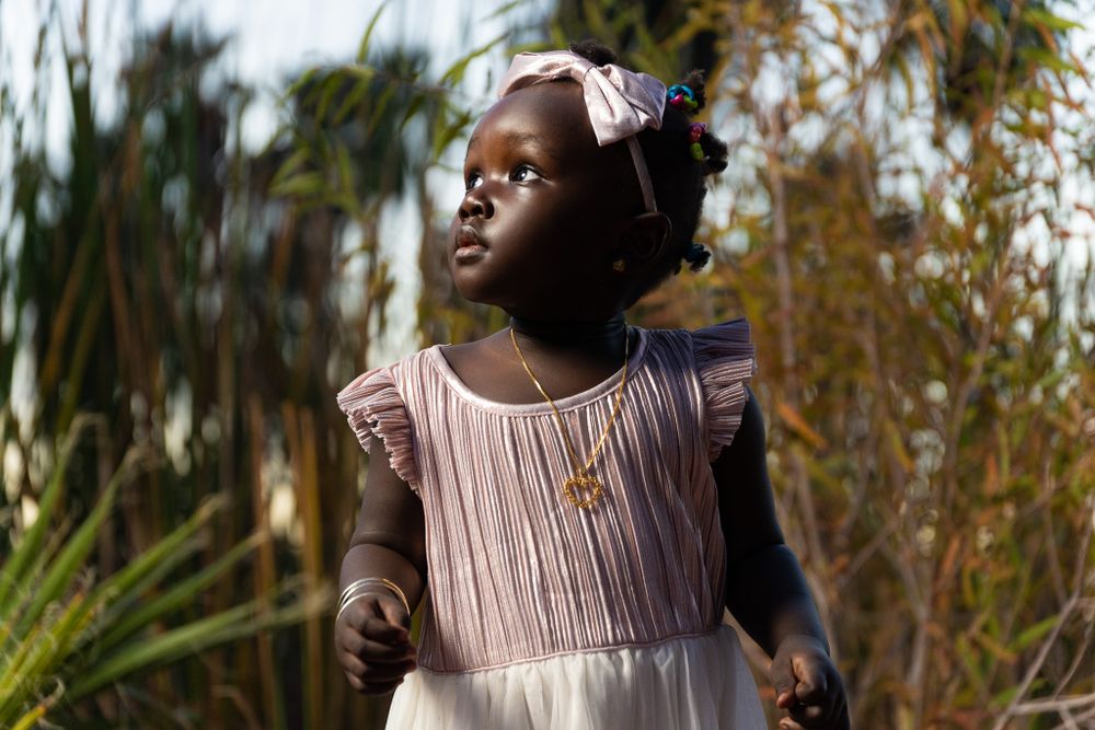 Outdoor autumn portrait series with soft natural lighting and trees in the background.