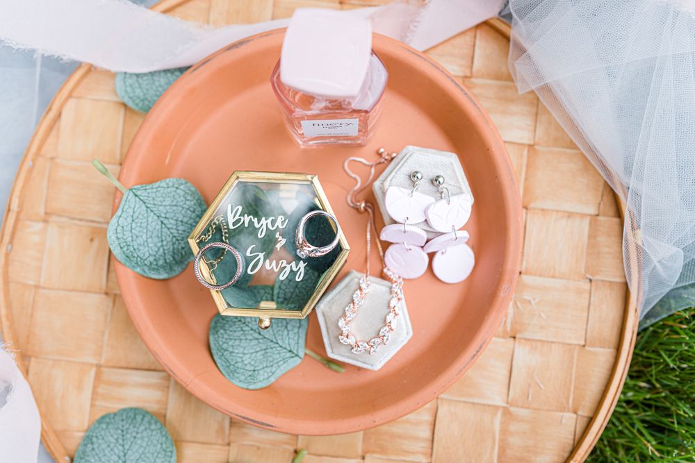 Wedding details featuring coral and mint green accents on woven charger plates.