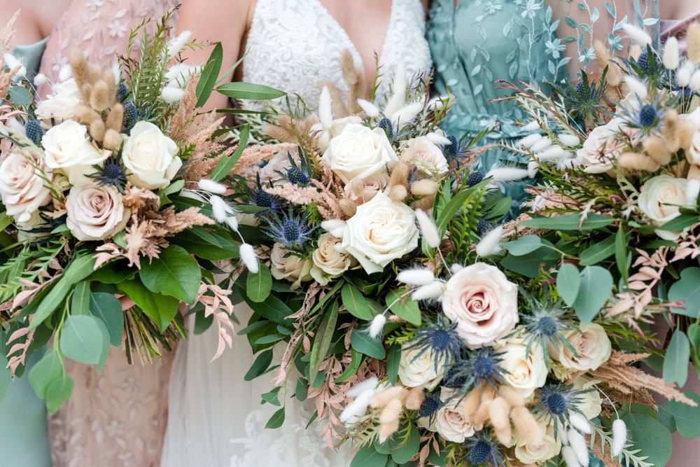 Elegant wedding bouquet with blush roses, white flowers, and eucalyptus greenery.