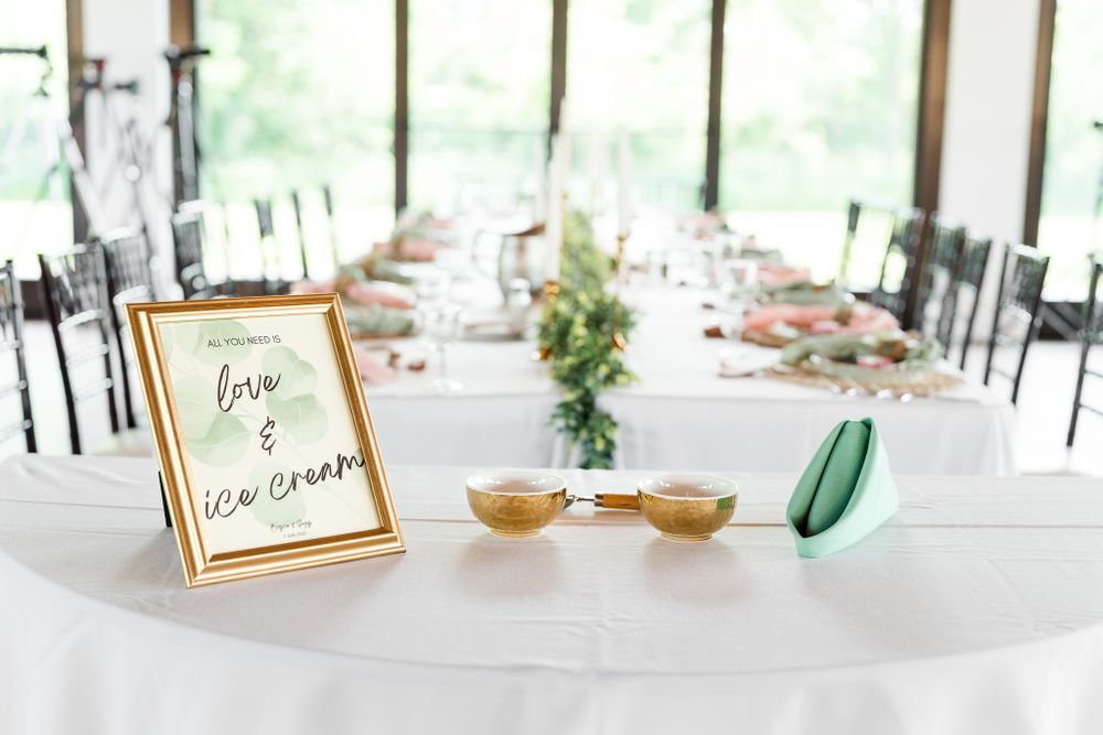 Modern reception setup with white tablecloths and place settings in an elegant banquet space.