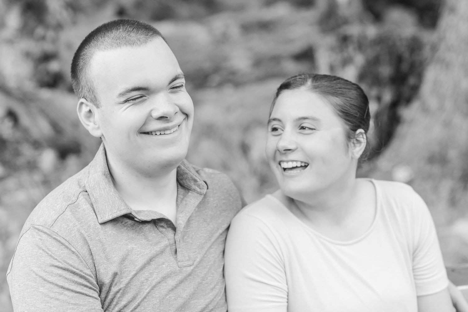 Black and white portrait series showing a couple's joyful expressions and laughter.
