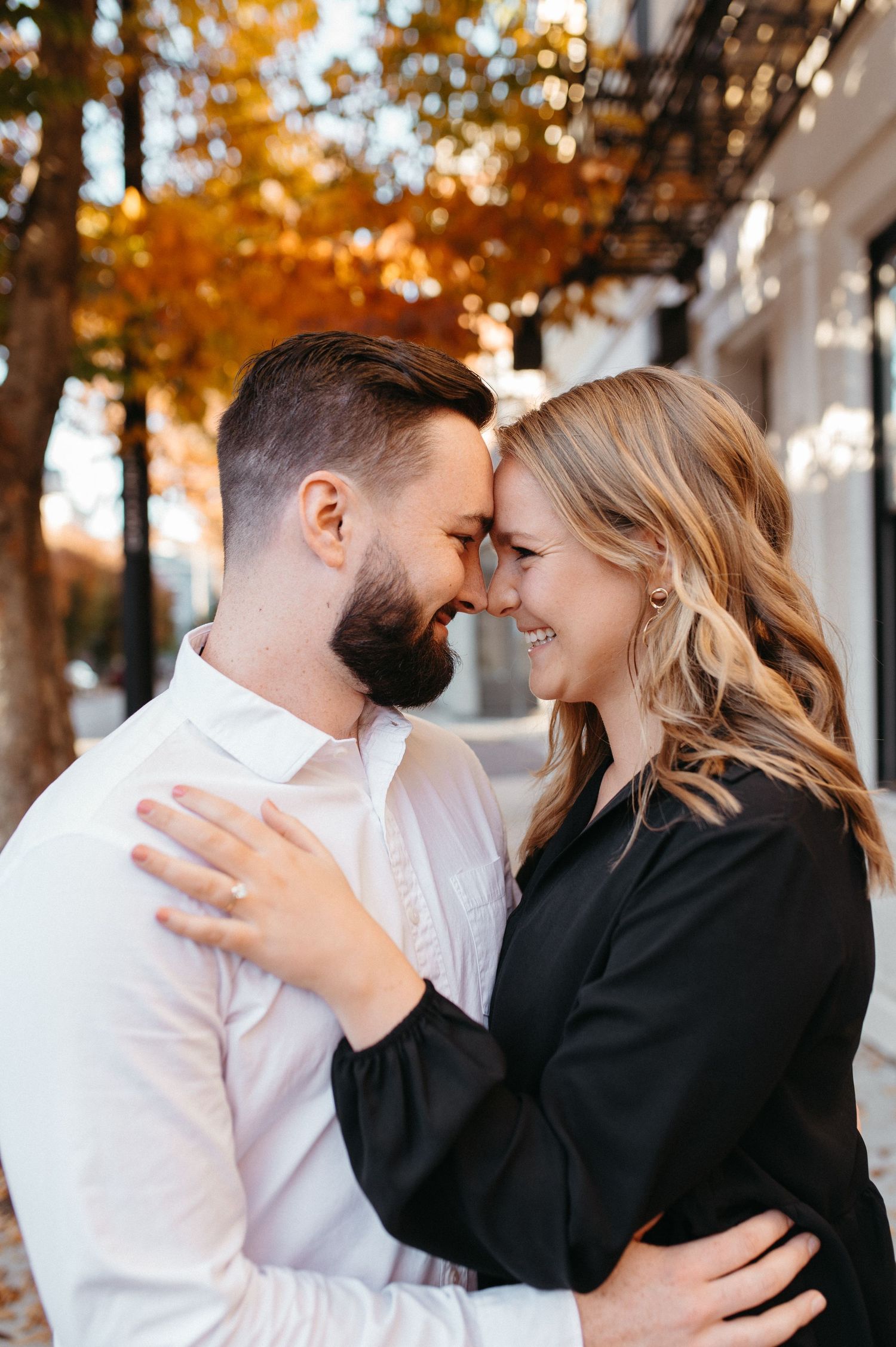 A romantic engagement photo showing a sparkling ring during an intimate moment.