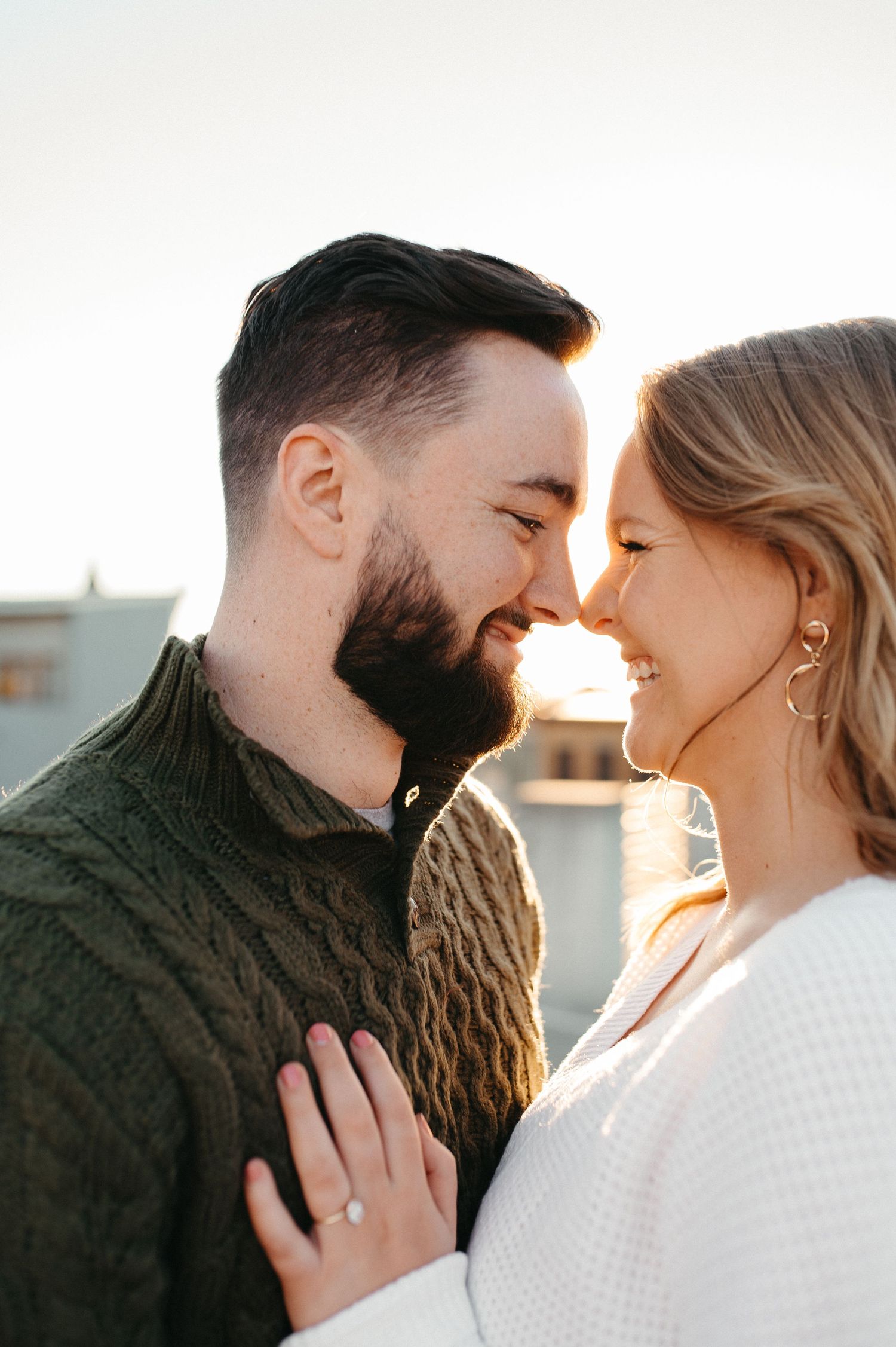 An intimate close-up of a couple sharing a loving moment at sunset.