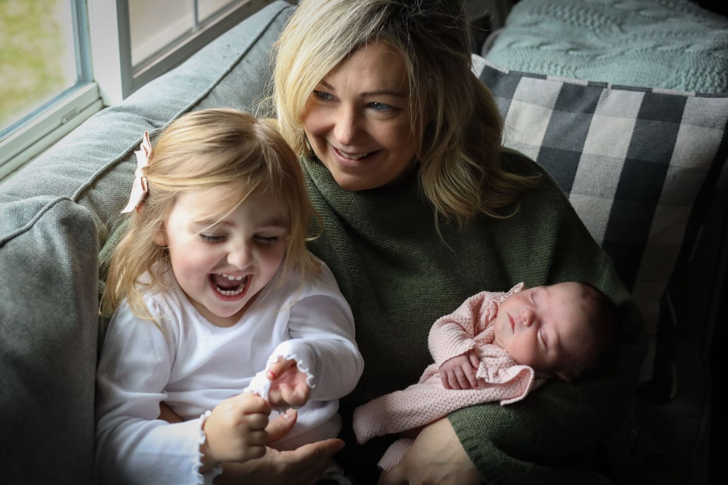 A joyful moment shared on a cozy couch with laughter and smiles.