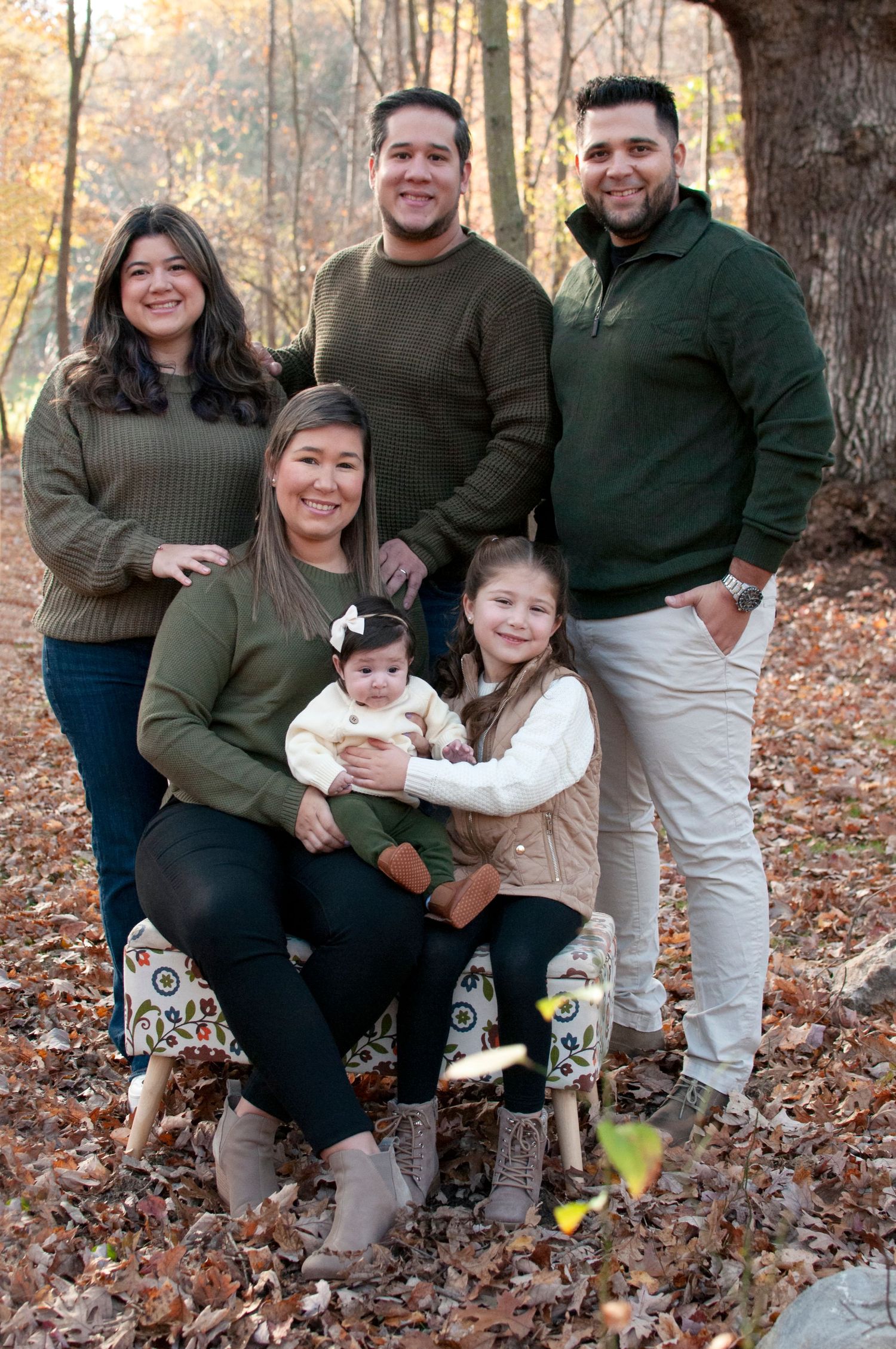 Extended family photo near large oak tree