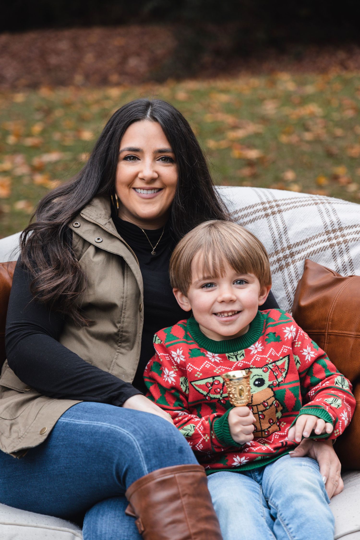 Holiday family photos featuring festive Christmas sweaters and cozy outdoor seating.