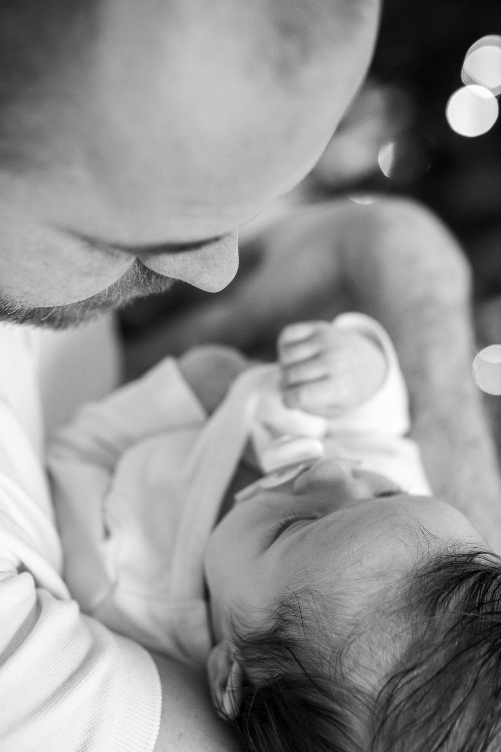 A father is holding a newborn baby.