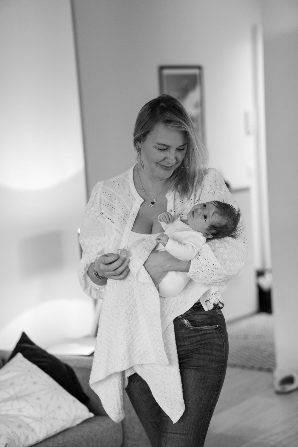 A woman is holding a baby.