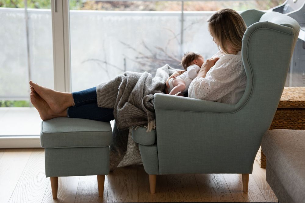 A woman is breastfeeding a newborn.