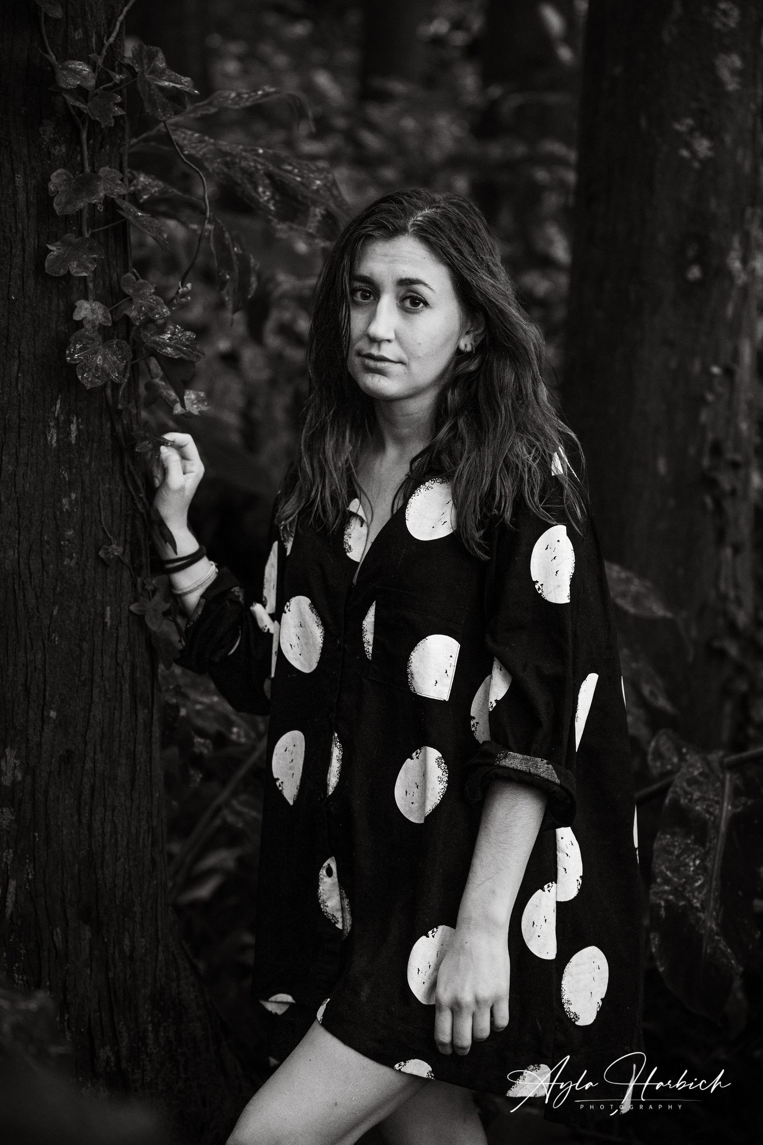 Portrait in nature. Person surrounded by vegetation, jungle feeling.