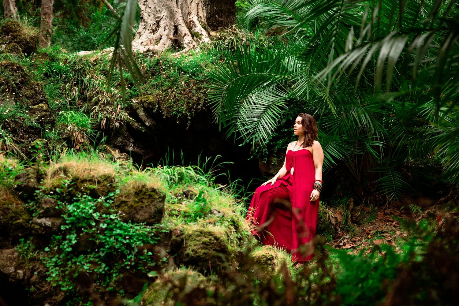 Portrait in nature. Person surrounded by green vegetation, jungle feeling.