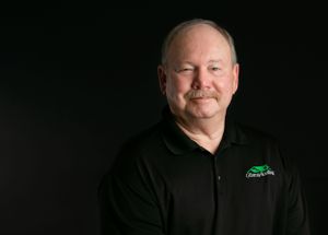 A corp headhsot of a man with a grin. Greenville SC Boudoir, Easley SC Boudoir, Upstate SC boudoir