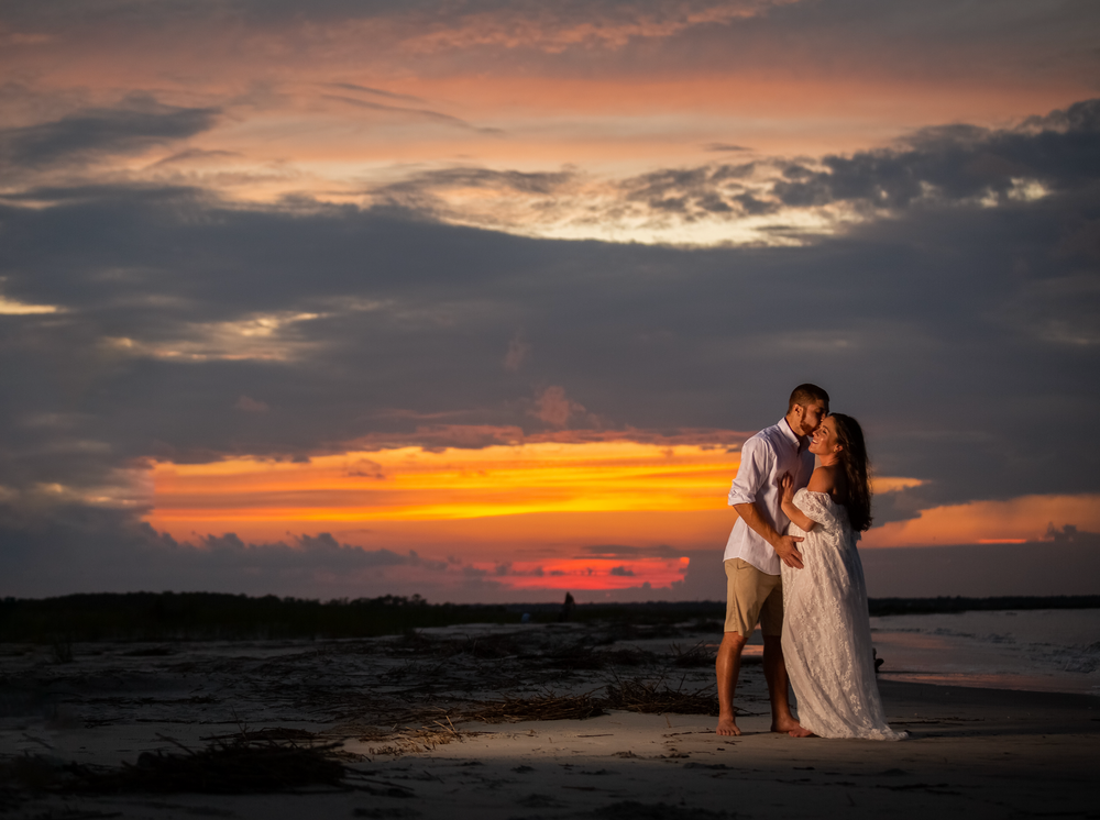 Pregnant couple beachside-tide pool at sunset Folly Beach