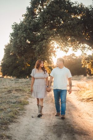 Couple taking a walk under a tree