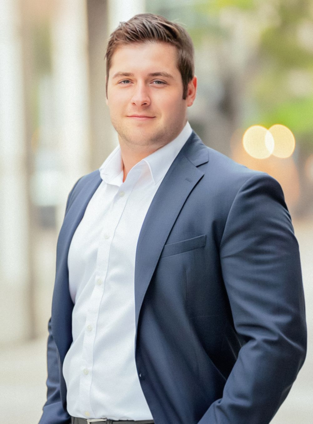 Business professional headshot of a man in blue suit