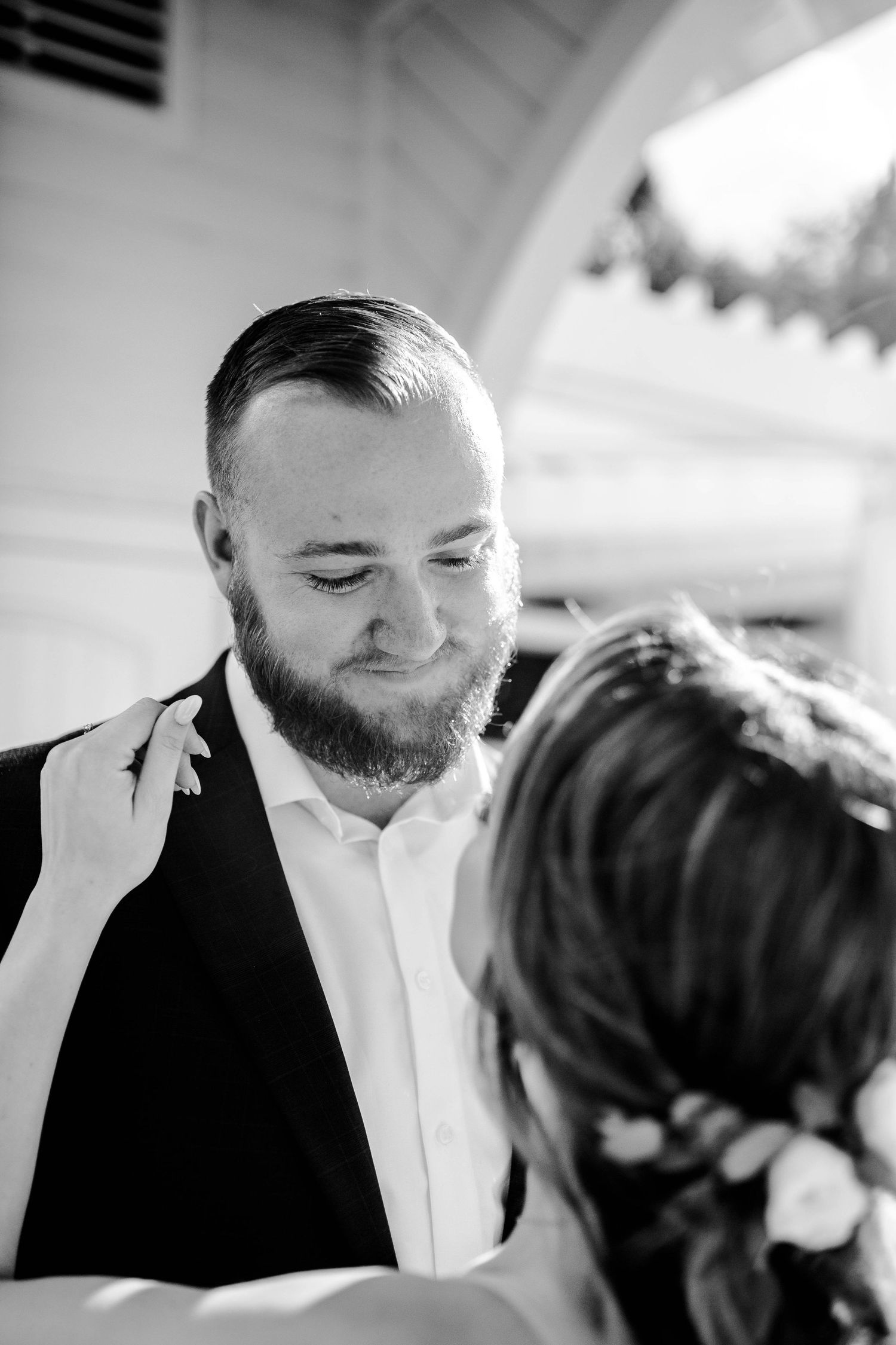A close-up black and white moment captured during a wedding celebration.