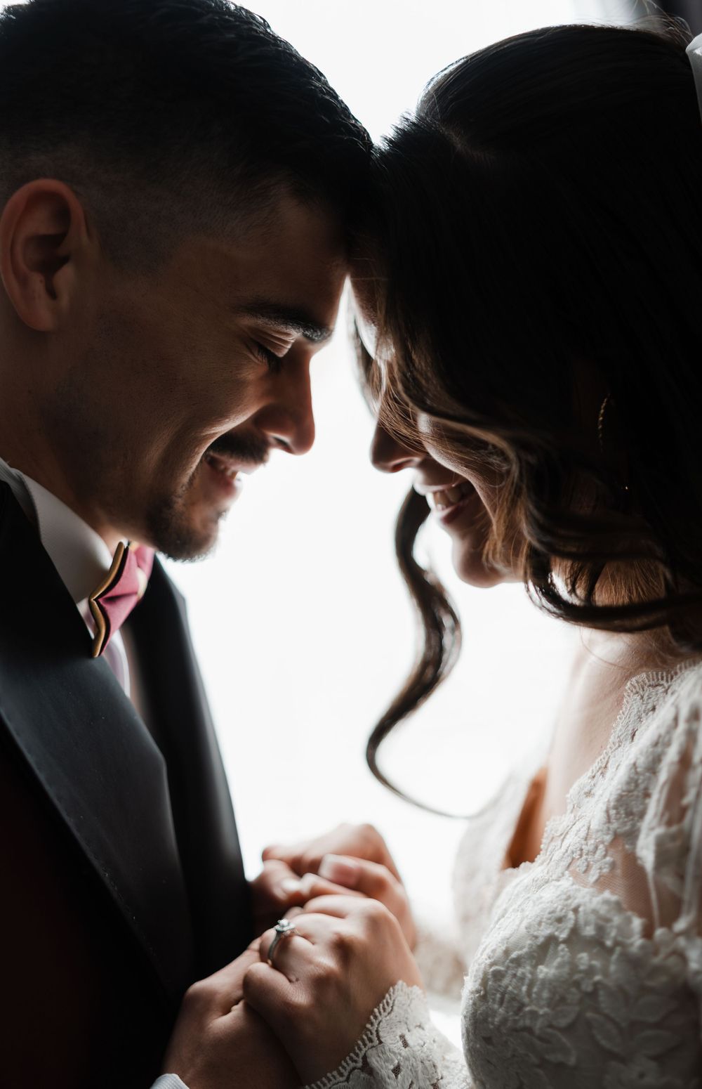 Intimate black and white silhouette portraits of couple in wedding attire.