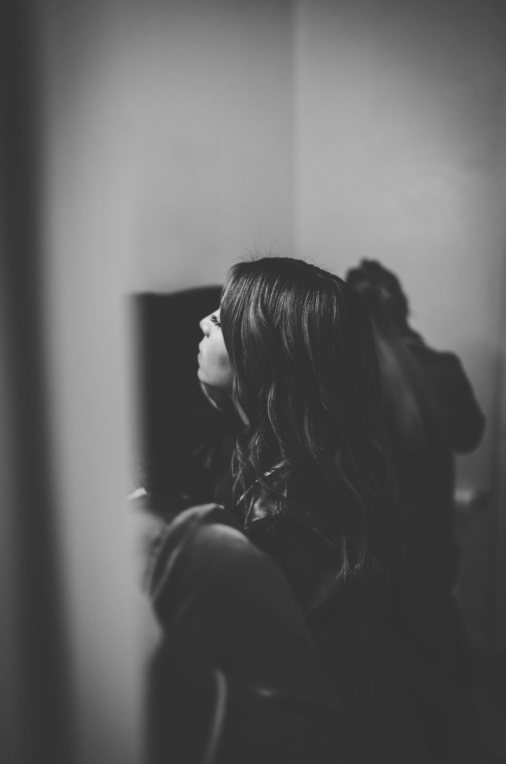 Artistic black and white profile silhouettes in moody lighting.