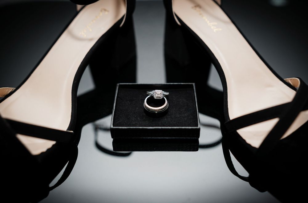 Close-up details of elegant black jewelry boxes arranged in dark lighting.