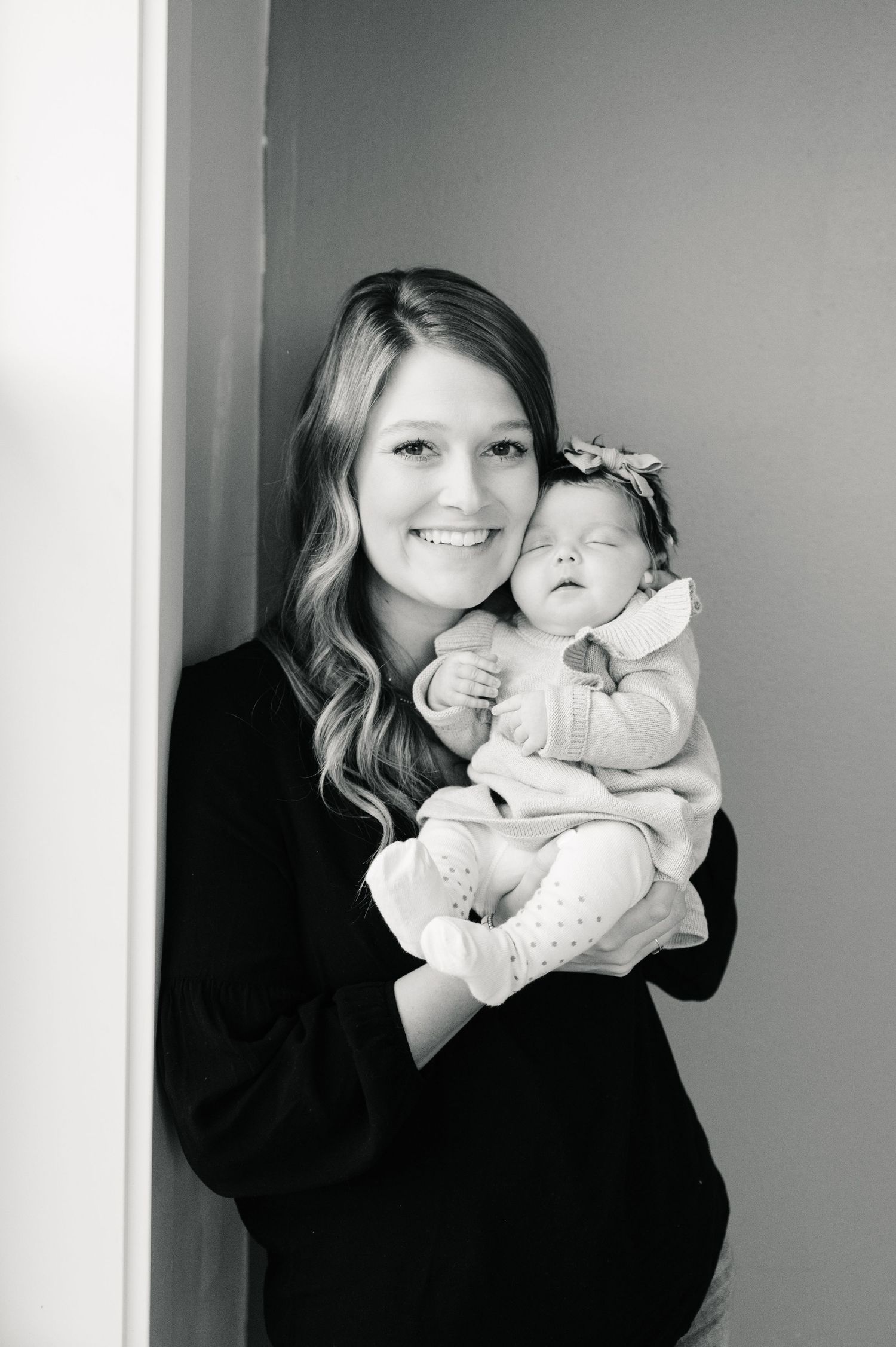 Black and white portrait with infant in white headband.