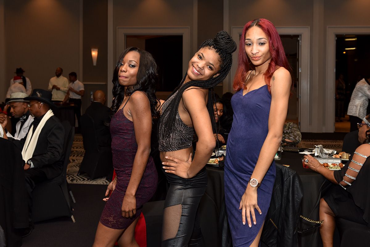 Evening social event with guests mingling in formal attire.