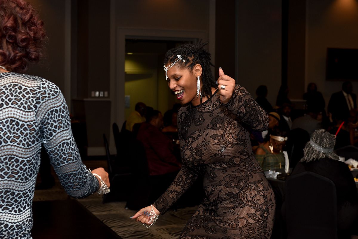 Indoor celebration event with guests dancing and socializing.
