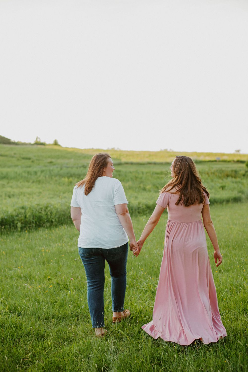 Same-sex couple walking pose during maternity session in Valley Forge Park