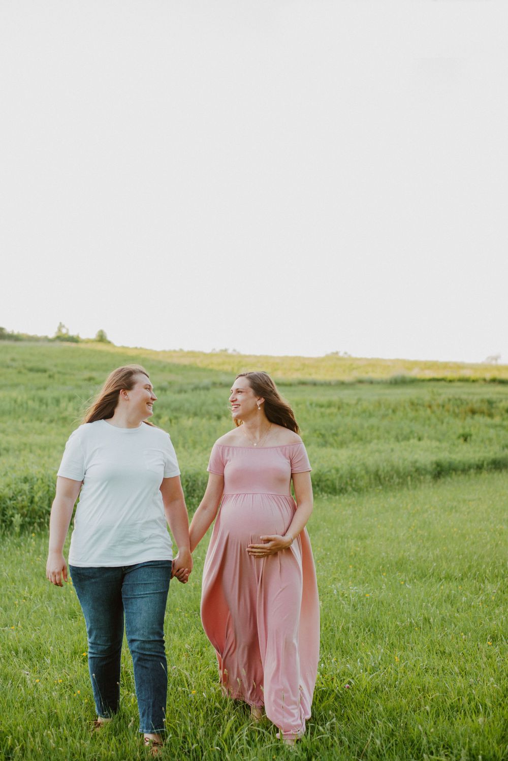 Same-sex couple walking pose during maternity session in Valley Forge Park